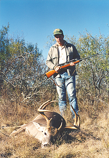 landowner standing next to deceased white-tailed deer